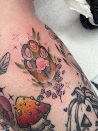 a tattoo of a pumpkin with a moth on it